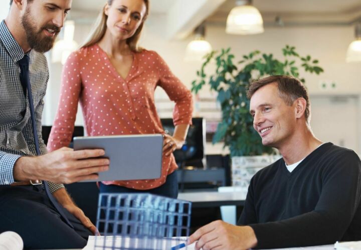 Office workers discussing how they can reduce business waste