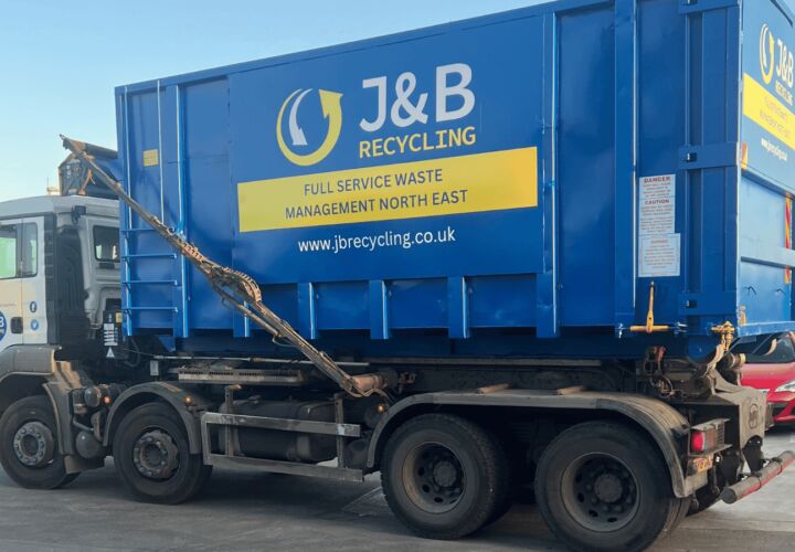 Large industrial skip being delivered on truck