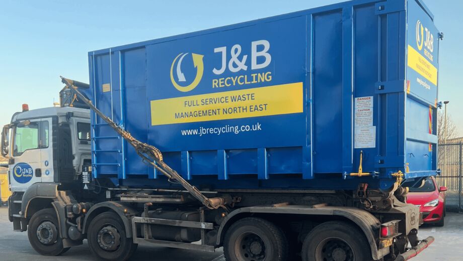 Large skip being delivered by truck